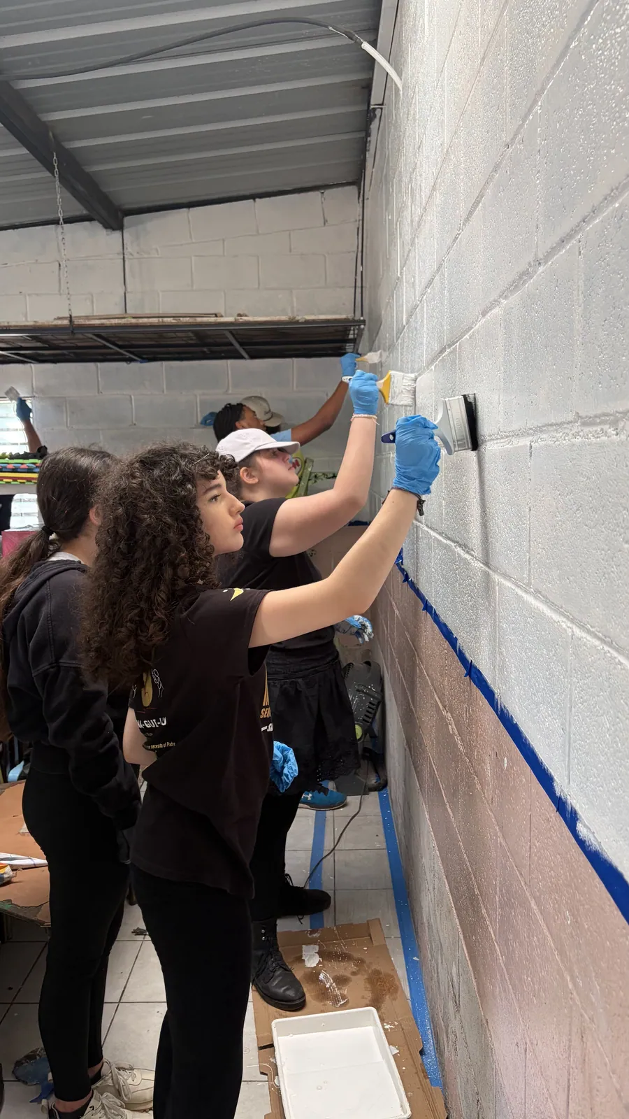 Learners painting and caring for their own studio space at Acton Academy El Salvador