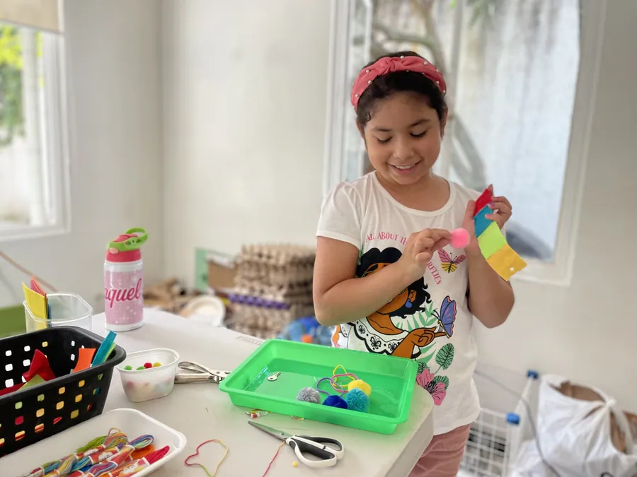 A learner at Acton Academy El Salvador working with real materials at her own pace