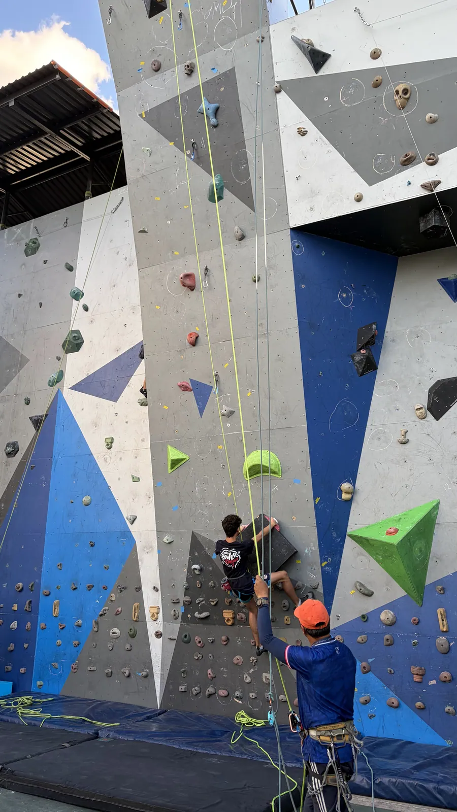 An Acton Academy El Salvador learner on the climbing wall where the school's rock climbing team trains
