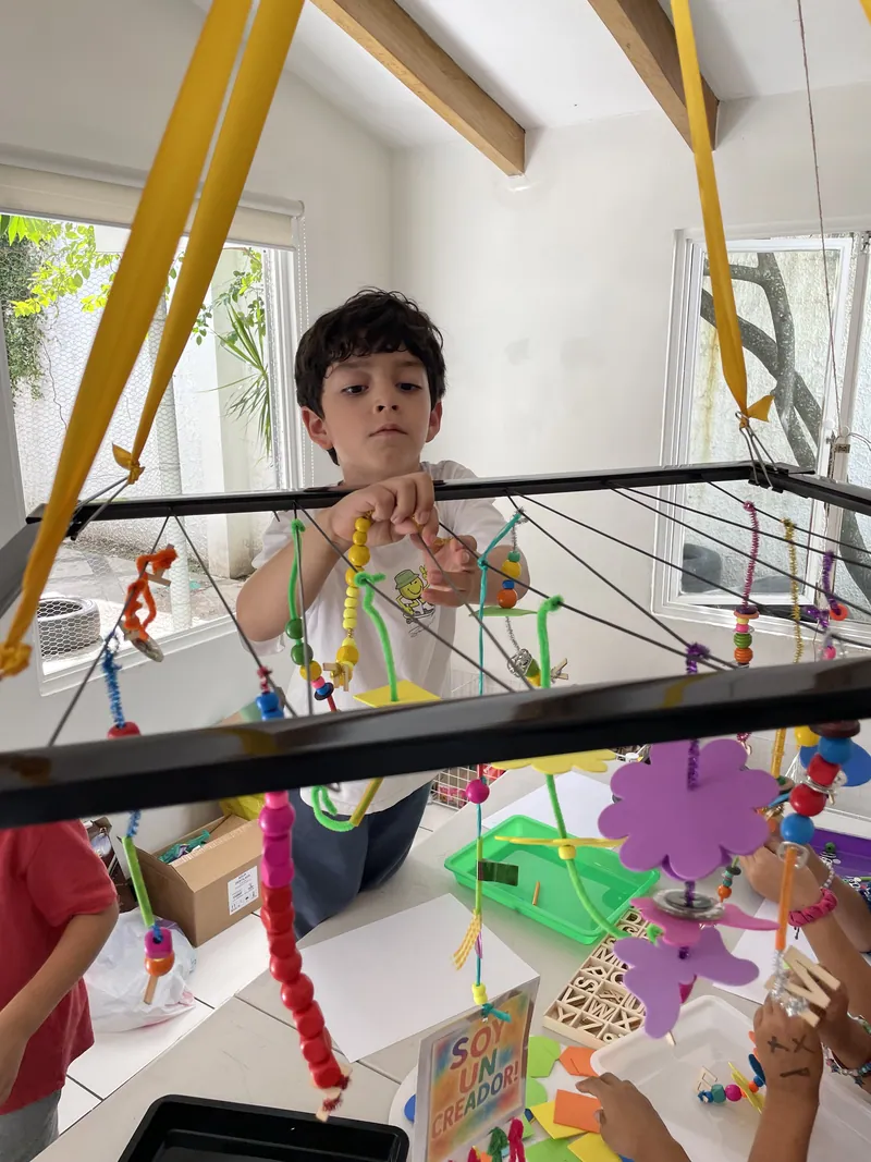 A learner assembling a moving structure he designed