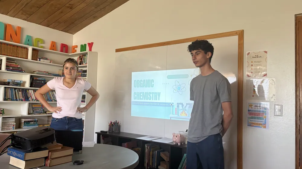 Two high school learners presenting an organic chemistry session at Acton Academy El Salvador