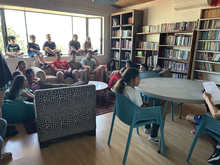 Older learners talking in the library at Acton Academy El Salvador
